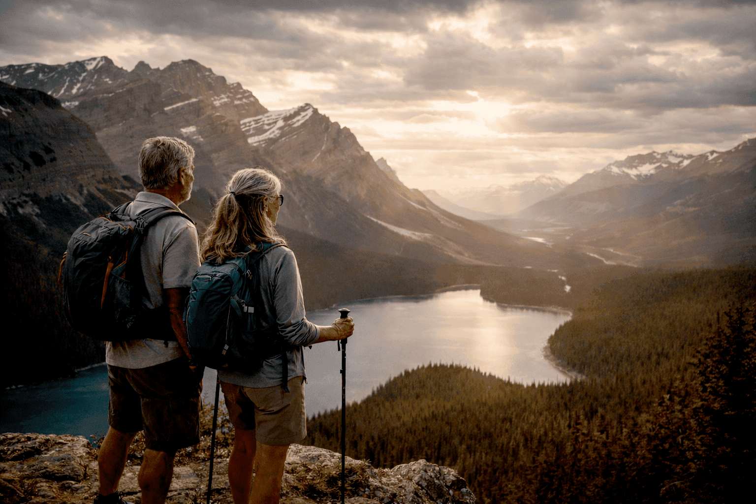 Golden hour over Peyto Lake Gen Z and Millennial Travel: a couple enjoying a mountain view in Banff, Canada, wearing backpacks, looking for experiential travel
